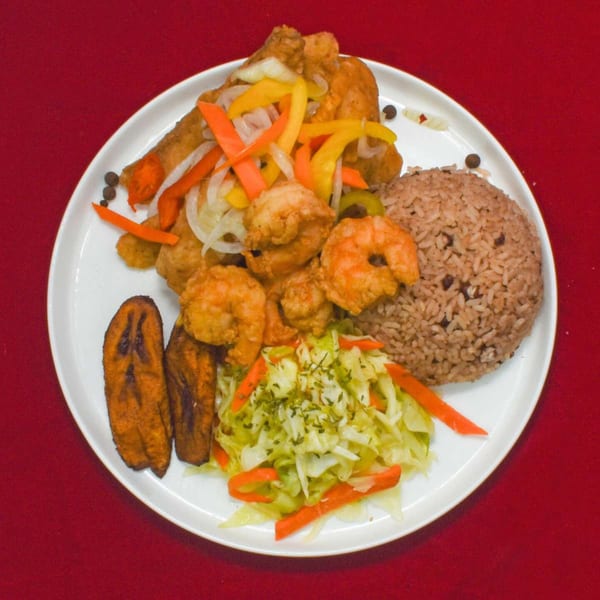 A Caribbean Delight meal with fried shrimp, rice and peas, plantains, and cabbage salad.